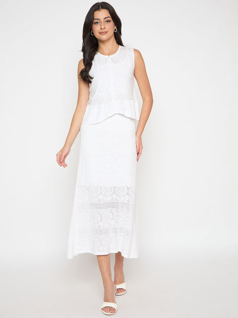 Woman wearing a white sleeveless dress with lace details on a white background