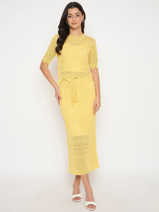 Woman wearing a yellow crochet dress on a white background