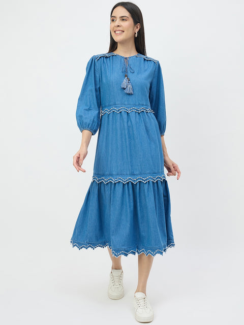 Woman wearing a blue dress with white sneakers on a white background