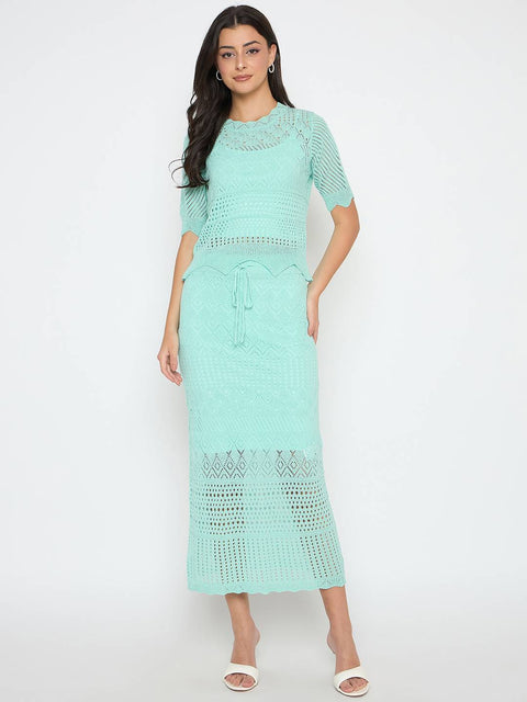 Woman wearing a light blue crochet dress on a white background