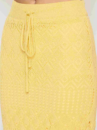 Yellow knitted skirt with drawstring waist on a white background